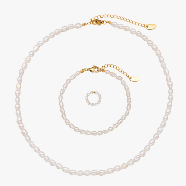 a necklace and bracelet with pearls on a white background