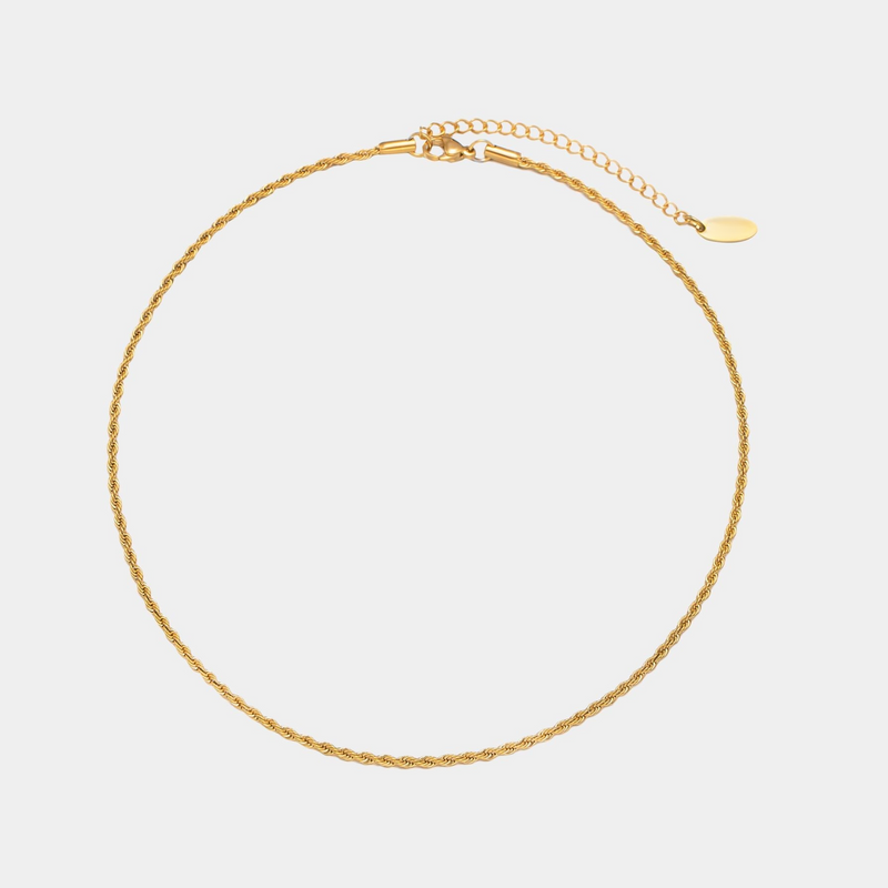 a gold chain bracelet on a white background