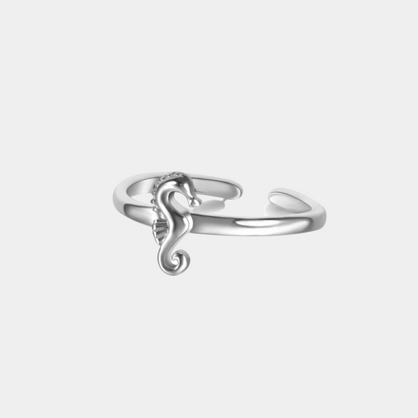 a silver ring with a lizard on it