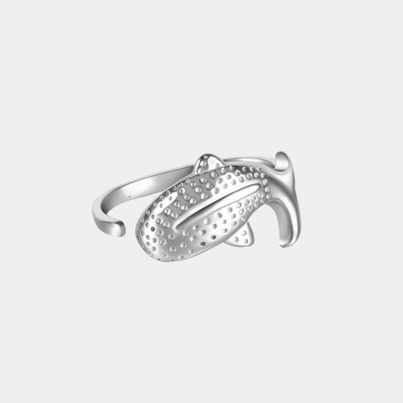 a silver ring with a design on it