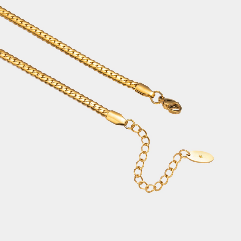 a gold chain with a clasp on a white background