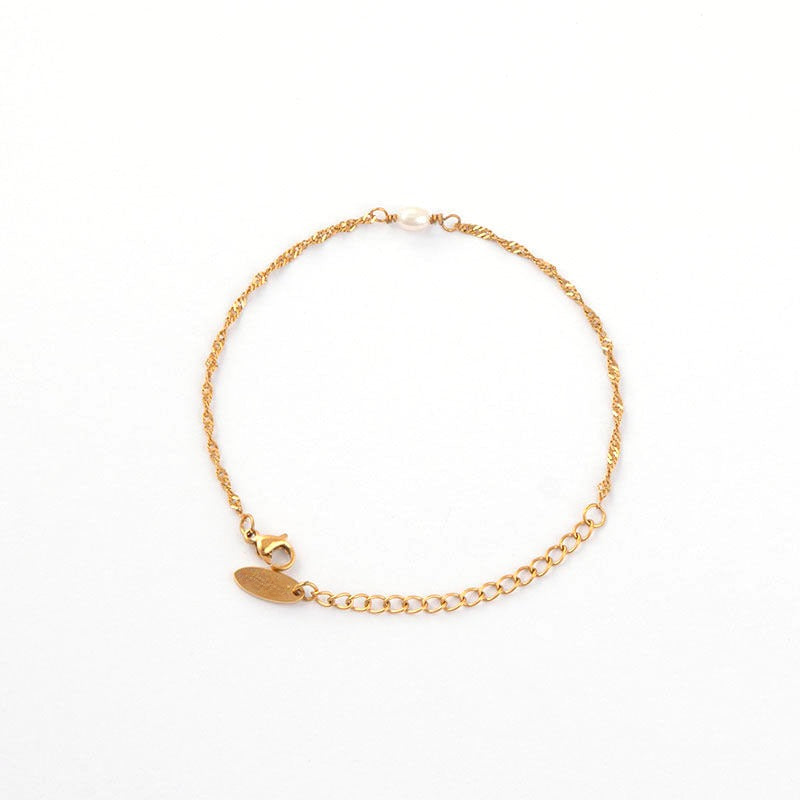 a gold chain bracelet with a heart charm