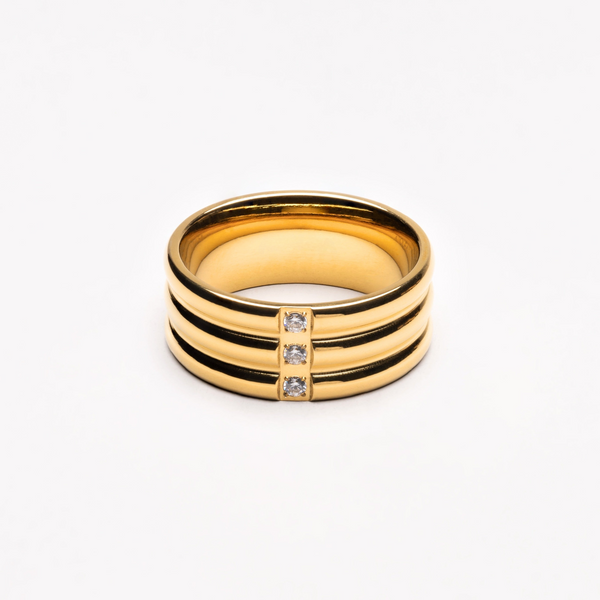 a gold ring with three diamonds on it