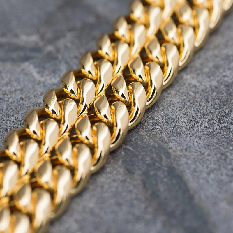 a close up of a gold chain on a surface