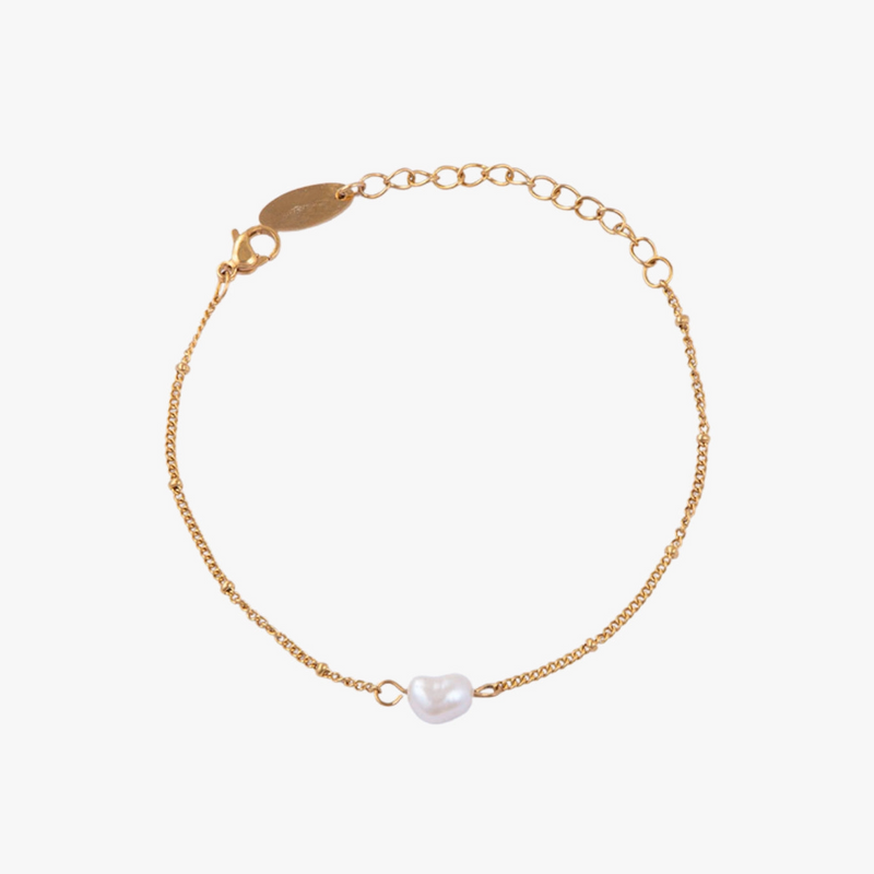 a gold chain bracelet with a white pearl