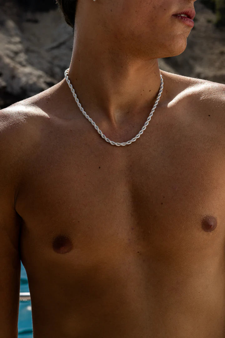 a shirtless man wearing a chain around his neck