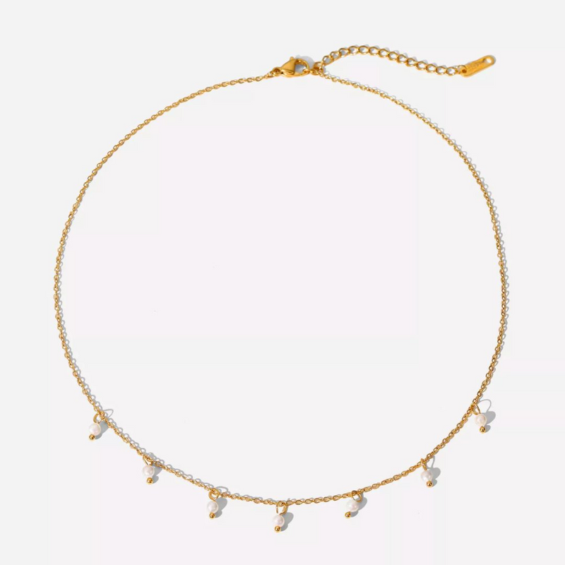 a gold necklace with five charms on a white background