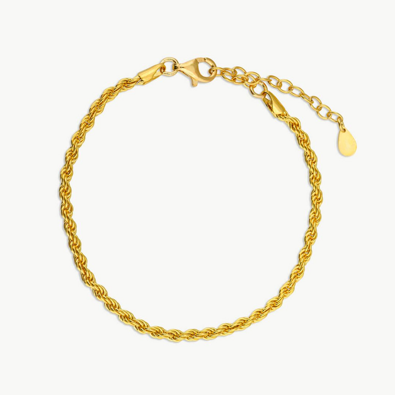 a gold bracelet with a heart charm