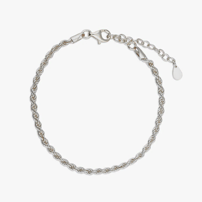 a silver bracelet with a heart charm