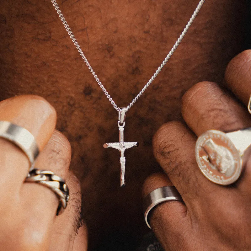 a man holding a cross and a coin