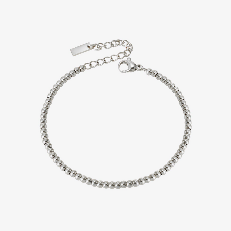 a silver beaded bracelet on a white background