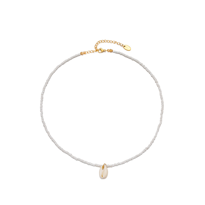 a white beaded bracelet with a gold charm