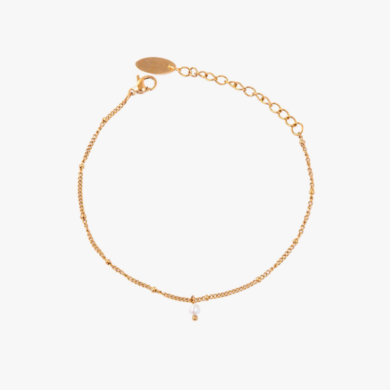 a gold chain bracelet with a single bea