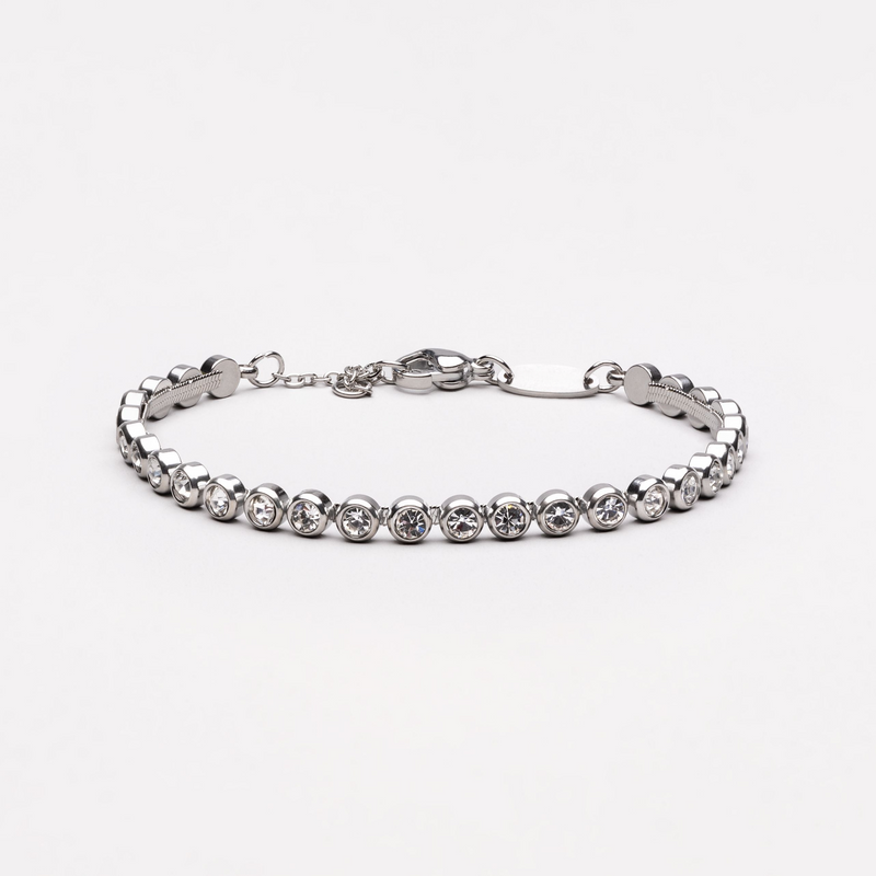 a silver bracelet with crystal stones on a white background