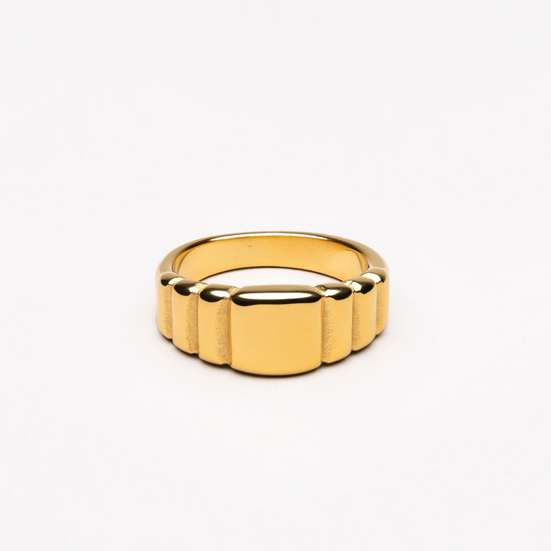 a gold ring on a white background