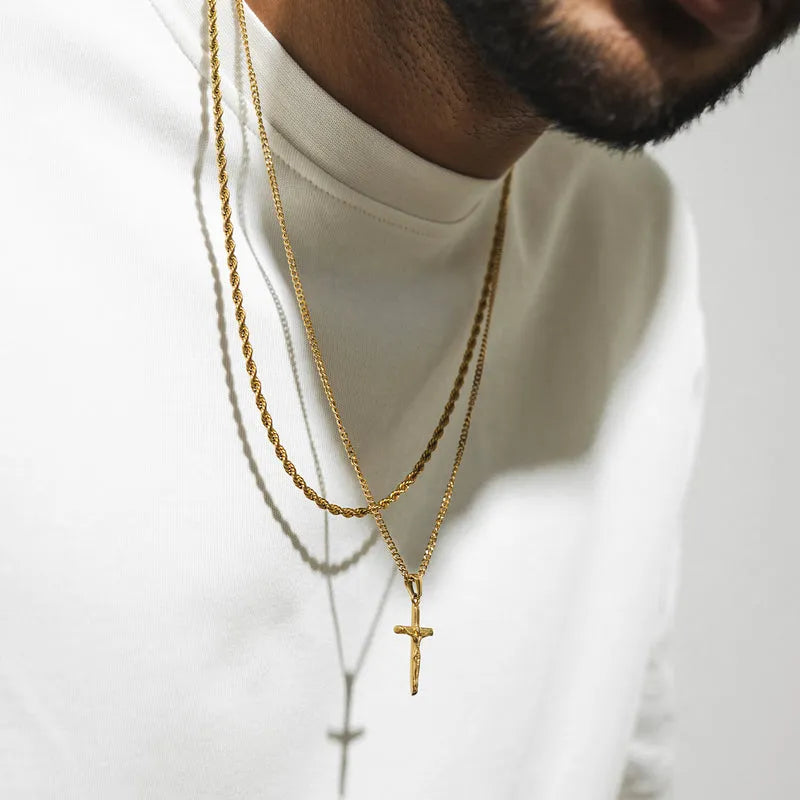 a man wearing a white shirt and a cross necklace