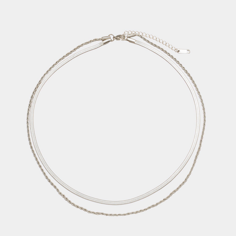 a pair of silver colored bracelets on a white background