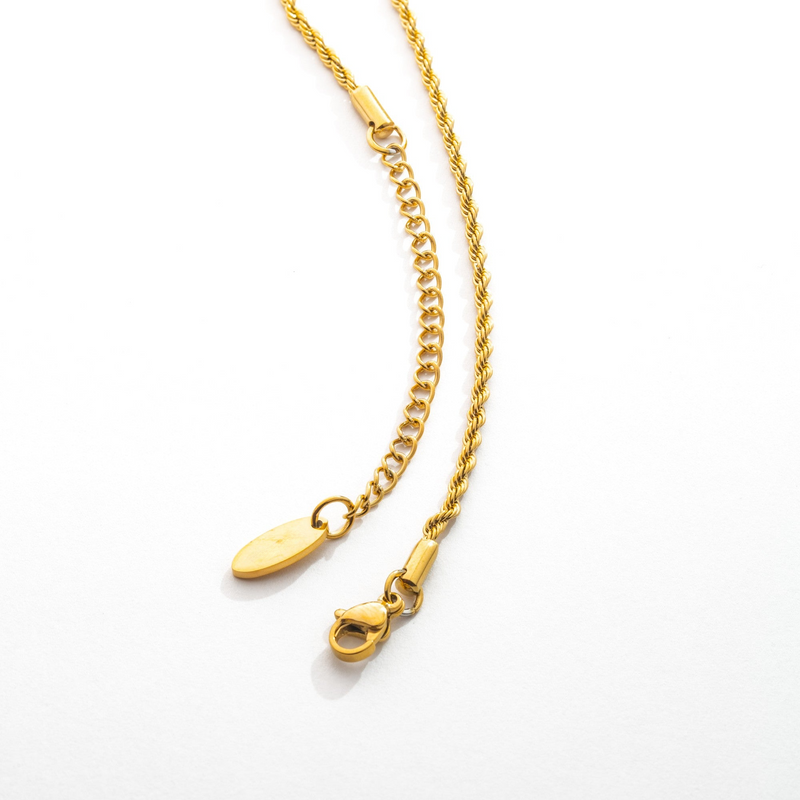 a gold chain with a pair of scissors on it