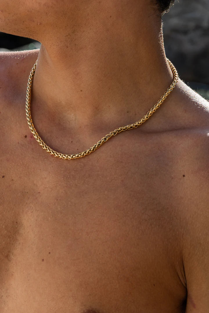 a close up of a person wearing a necklace