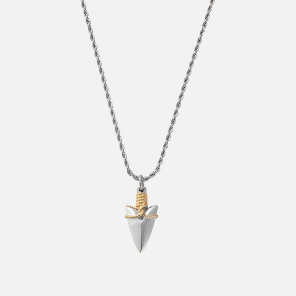 a silver and gold necklace with a bird on it