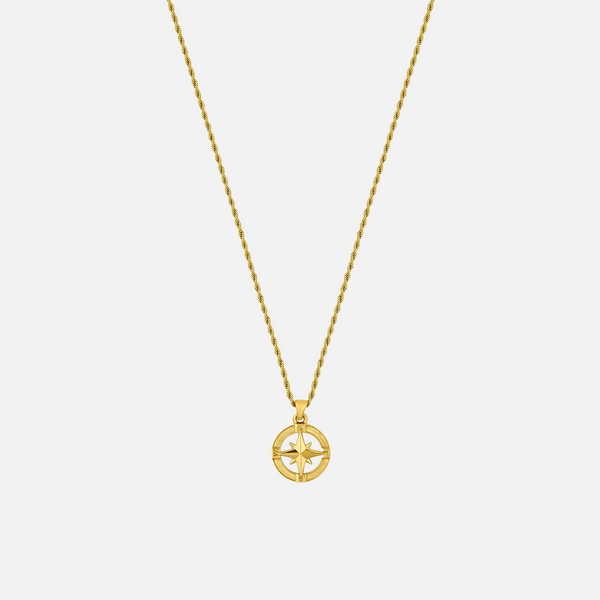 a gold necklace with a cross on it