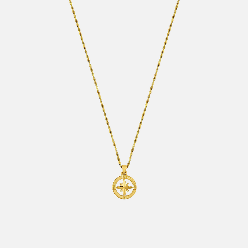 a gold necklace with a cross on it