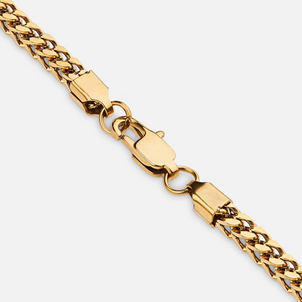 a gold chain with a clasp on a white background