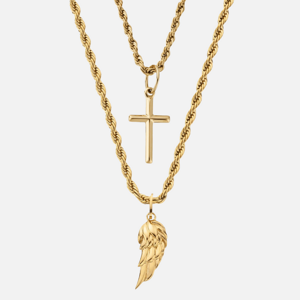 a cross and angel wings necklace on a white background