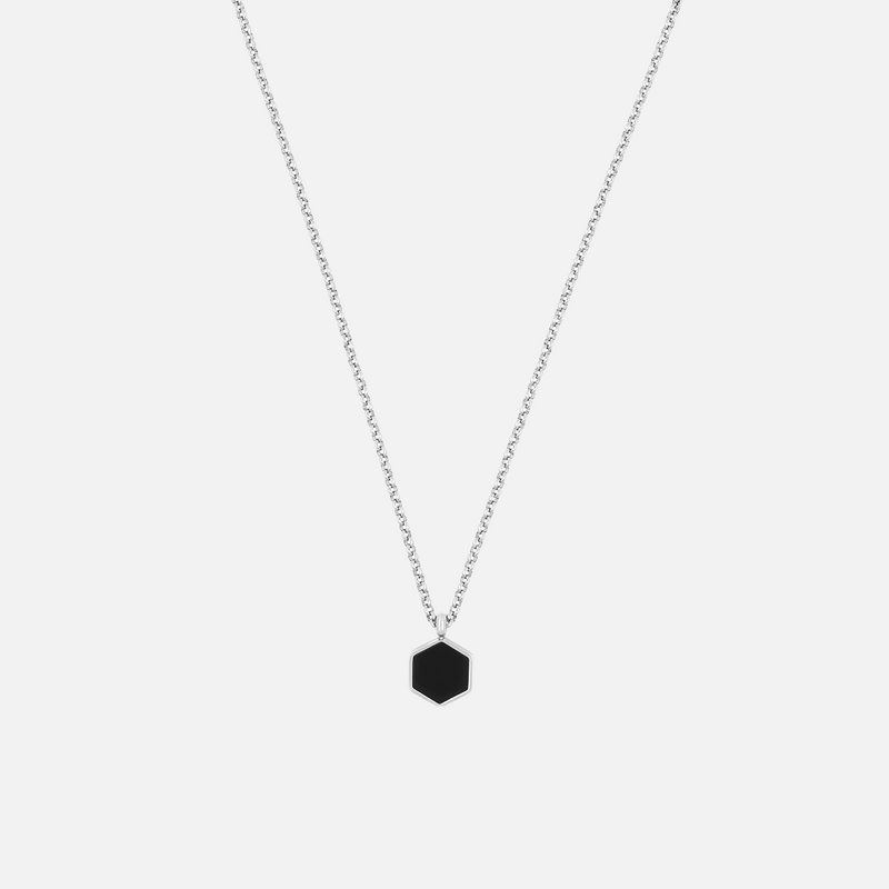 a necklace with a black hexagonal pendant on a chain