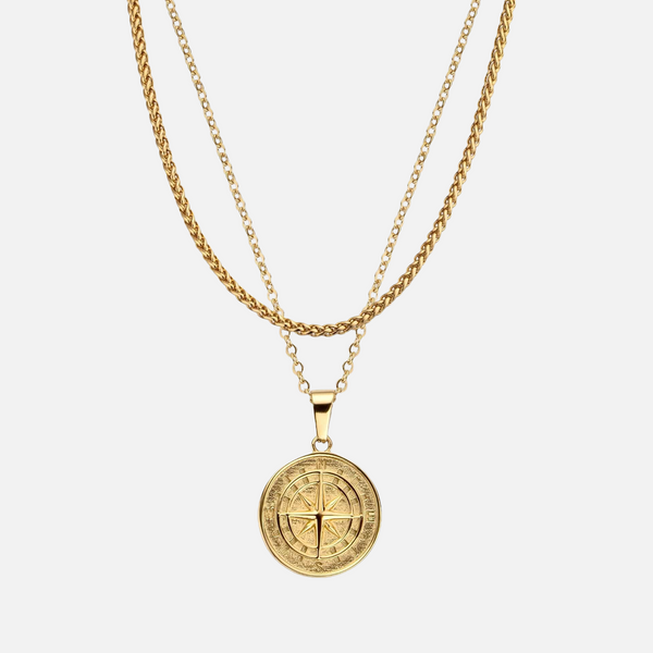 a gold necklace with a cross on it