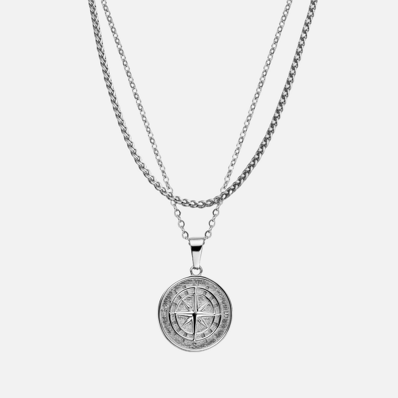 a silver necklace with a cross on it